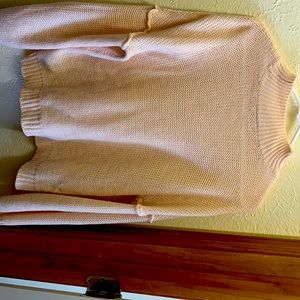 Light pink knit sweater with mock neck.